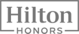 The image displays the Hilton Honors logo, featuring the text "Hilton" in a black rectangle with "HONORS" below it in smaller font.